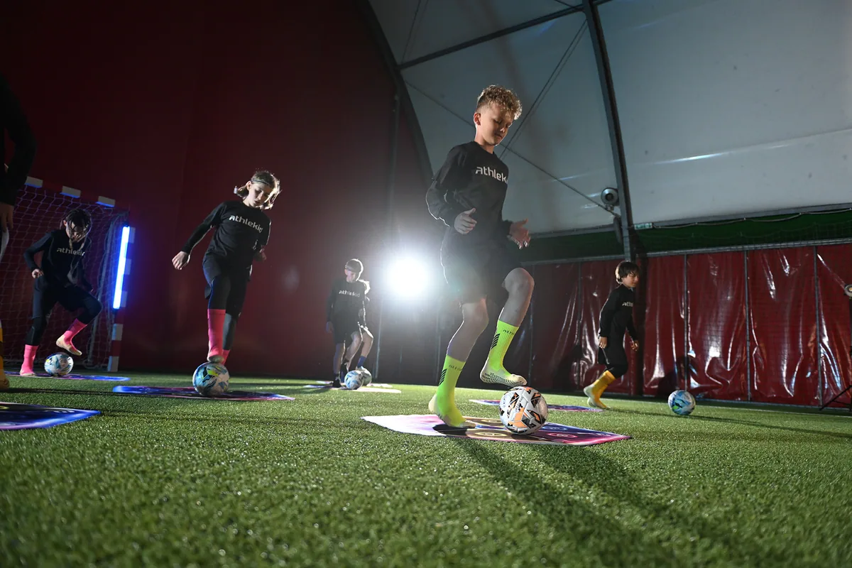 Children training on Athlekid mats laid out as a station during a club session