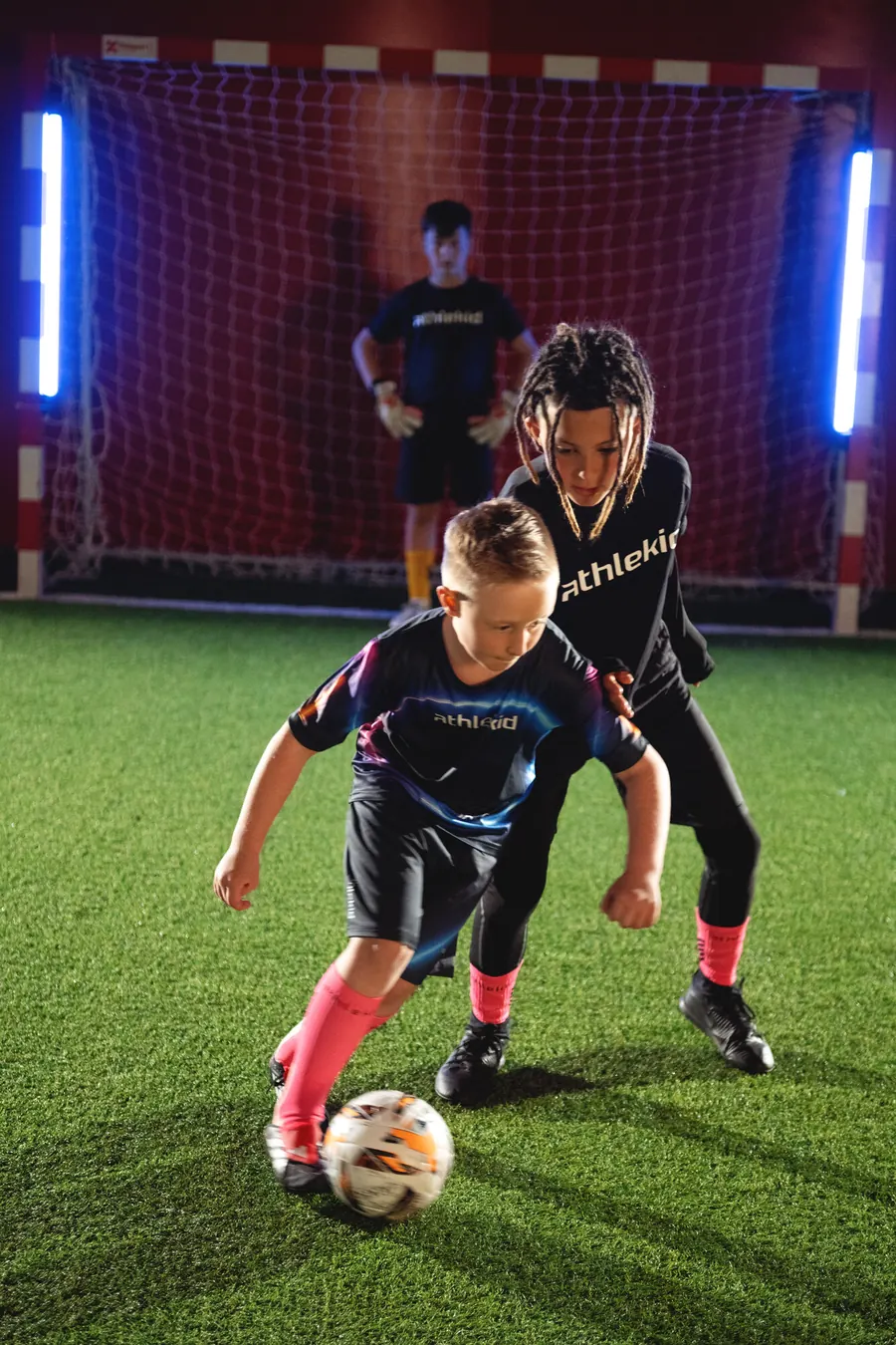 Two young players competing for the ball