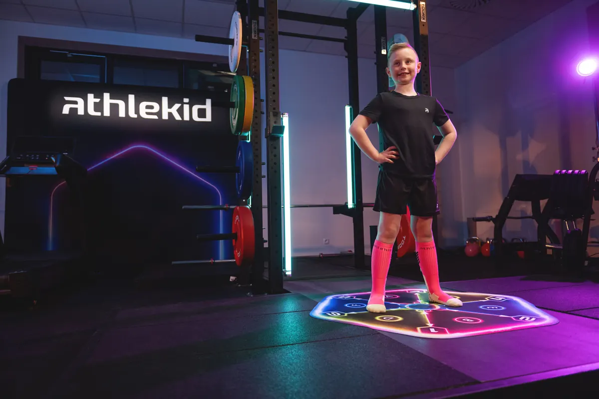 A boy training on the Athlekid mat in a studio